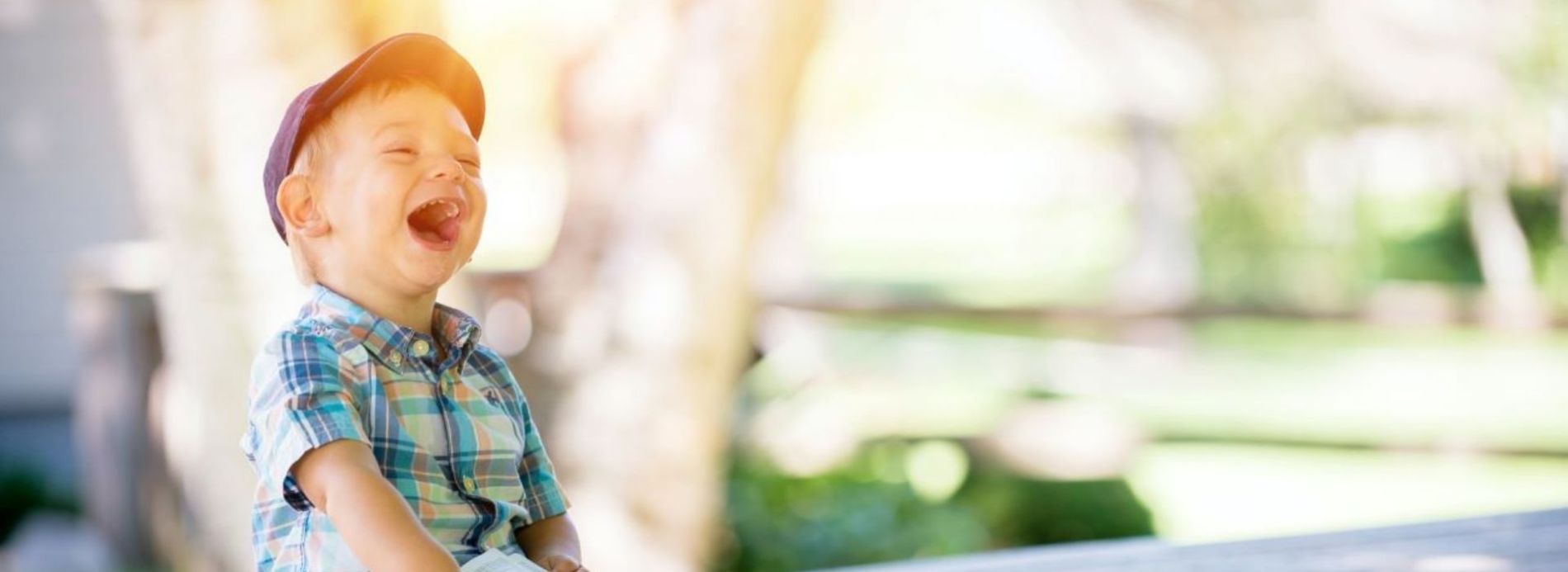 laughing child sitting on bench