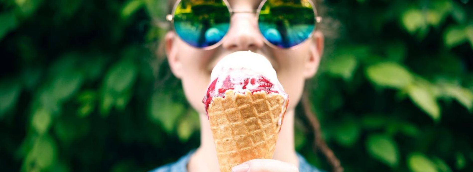 person in sunglasses with ice cream cone