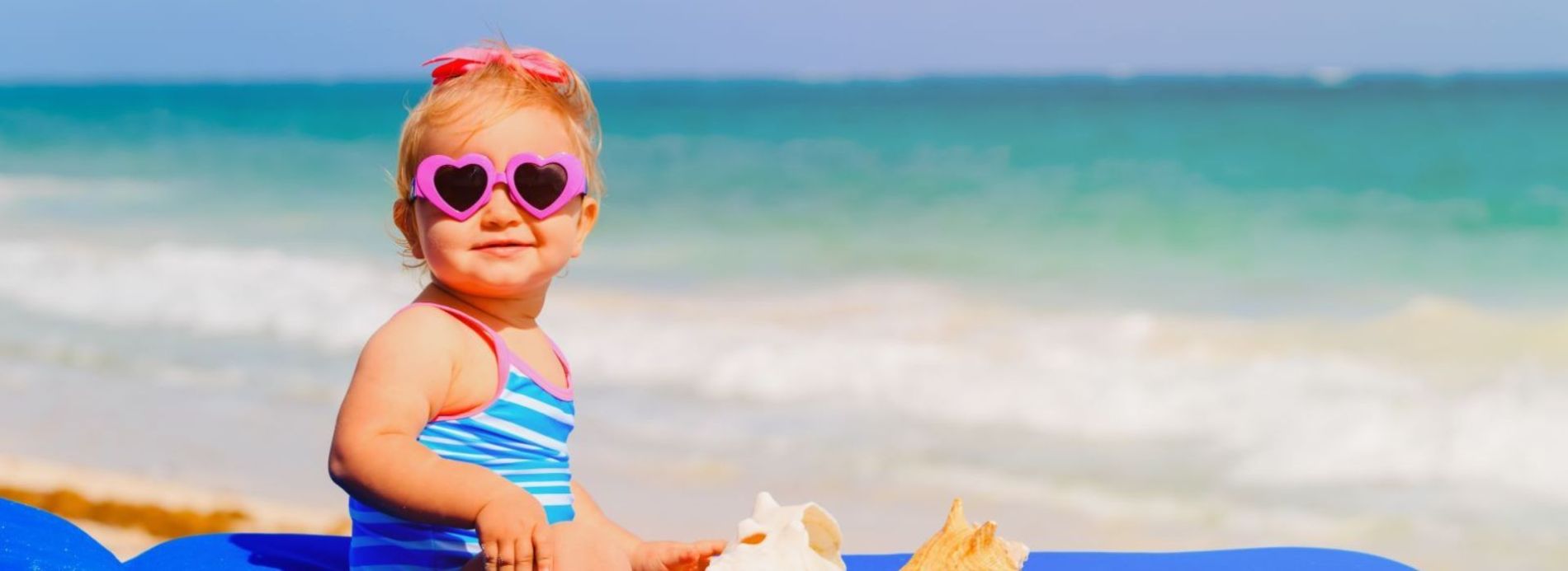 baby with sunglasses on beach