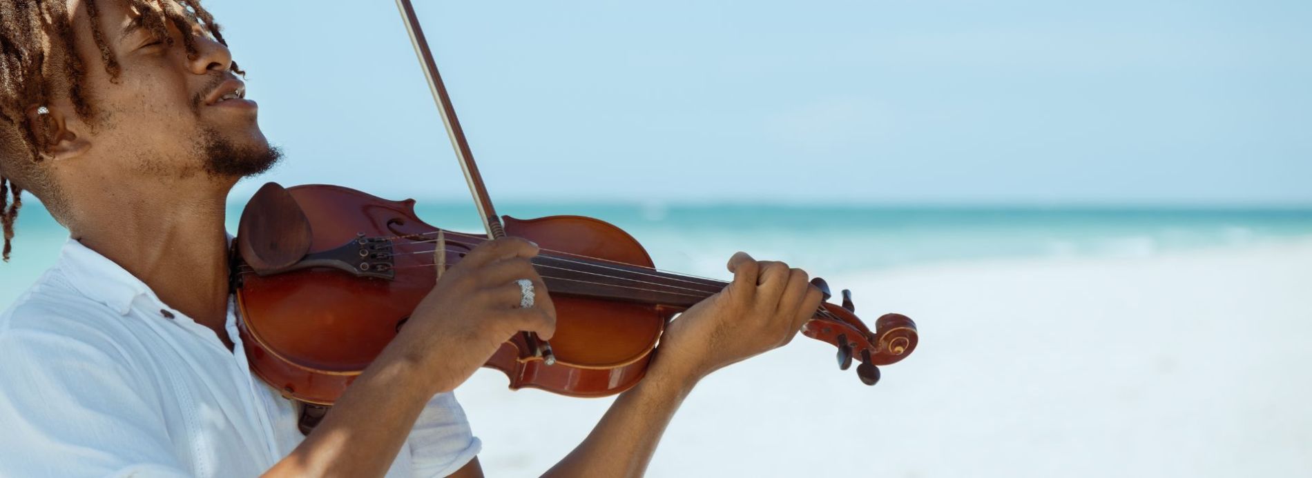 playing violin on the beach