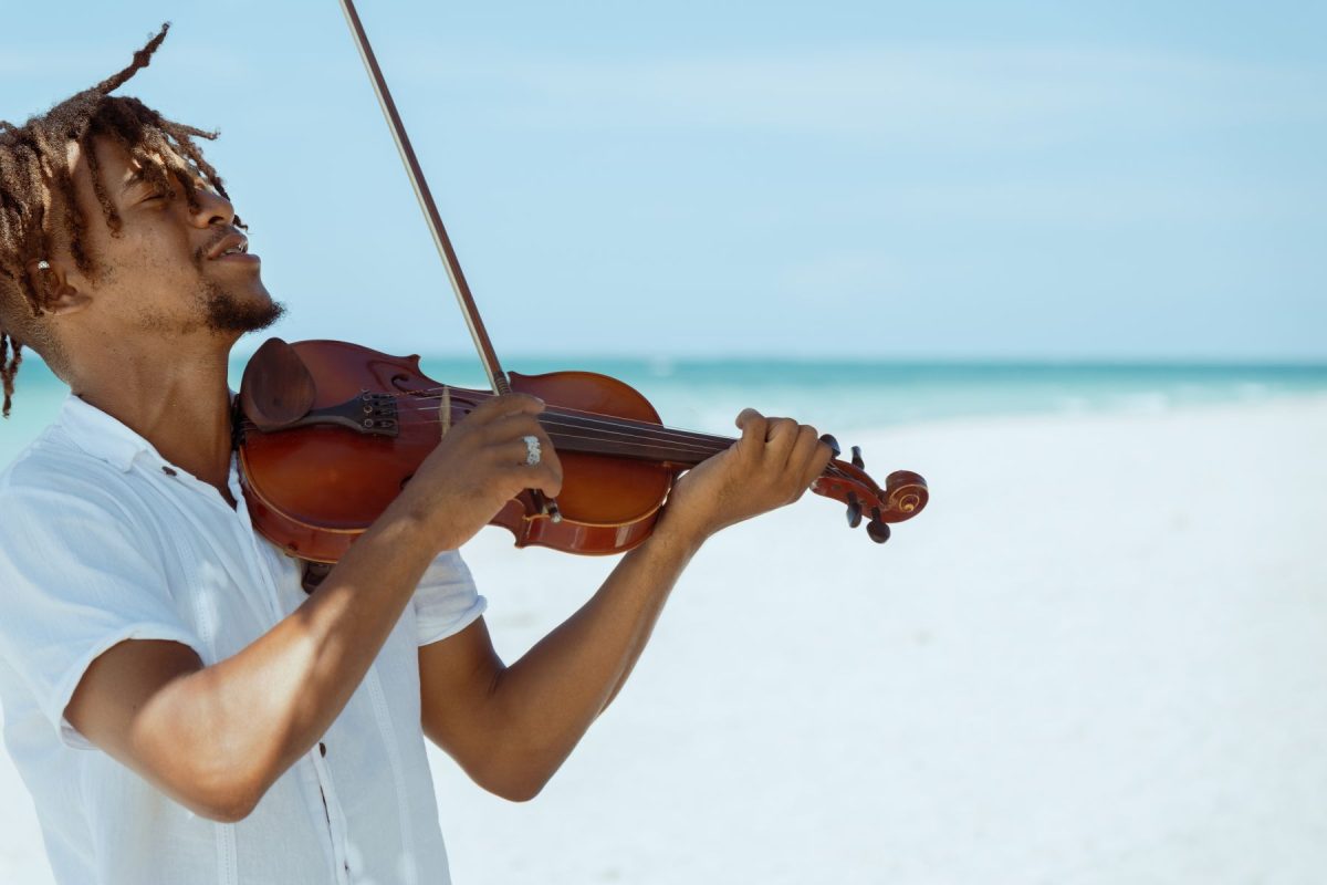 playing violin on the beach
