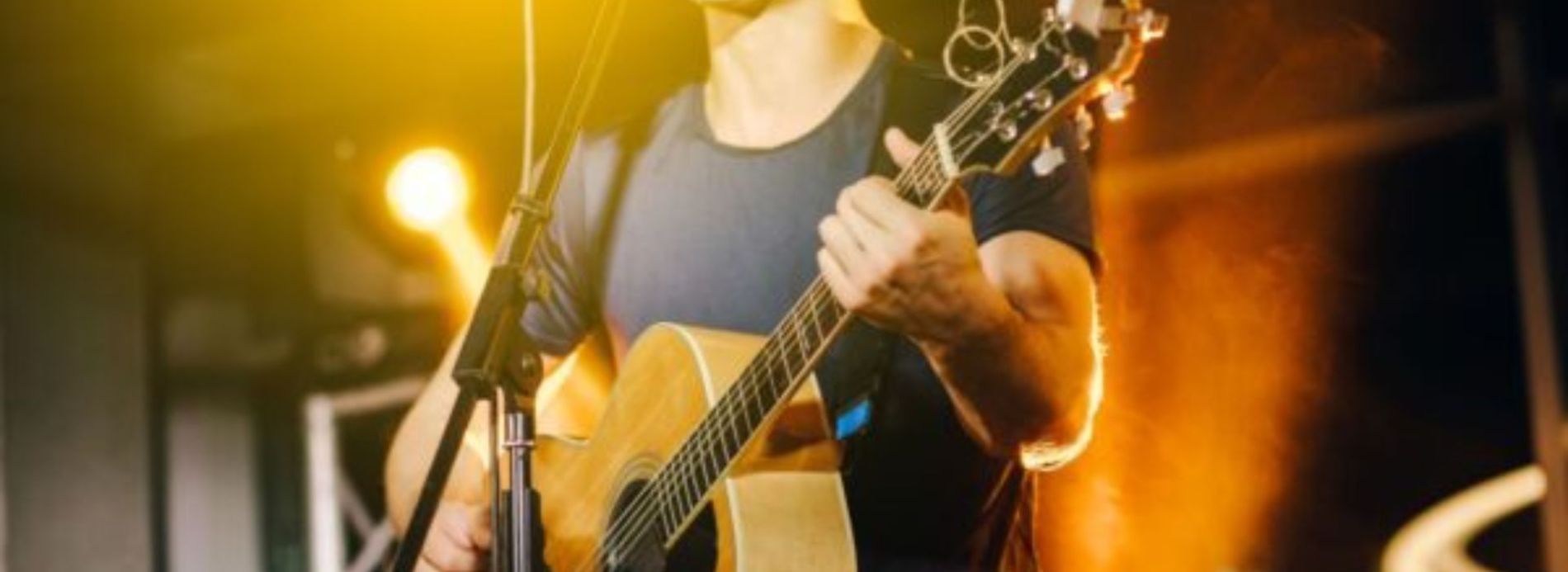 man playing guitar on stage