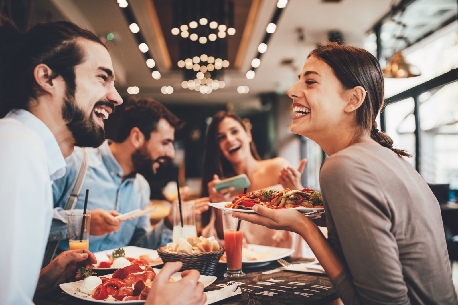 Group of friends enjoying a meal at Anna Maria Island restaurant